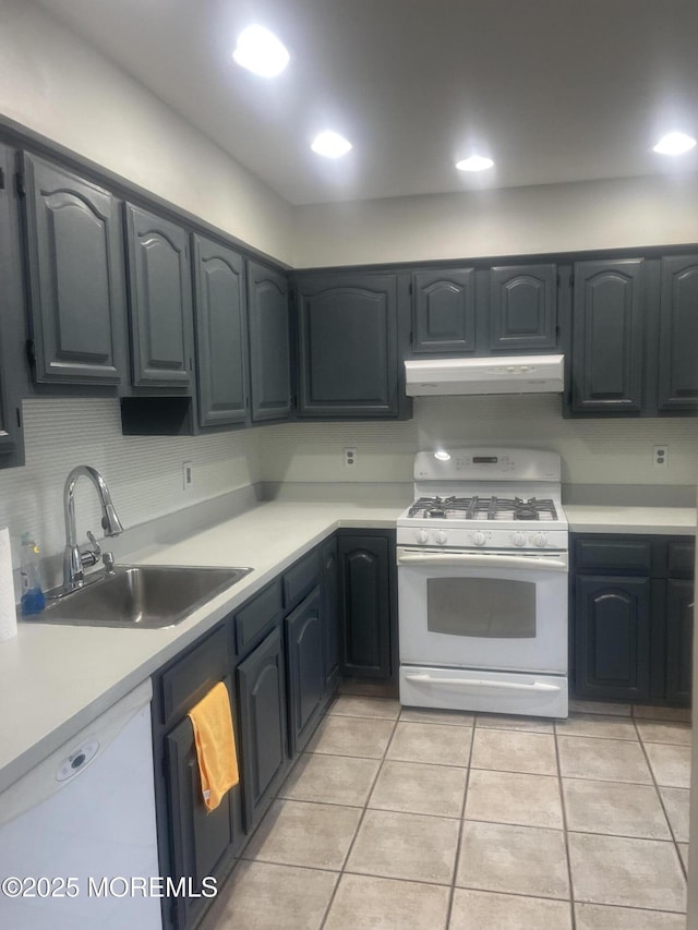 kitchen with sink, light tile patterned flooring, and white appliances