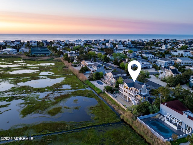 aerial view at dusk with a water view