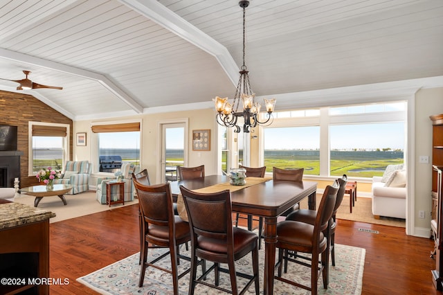 dining space featuring vaulted ceiling with beams, dark hardwood / wood-style floors, and a wealth of natural light