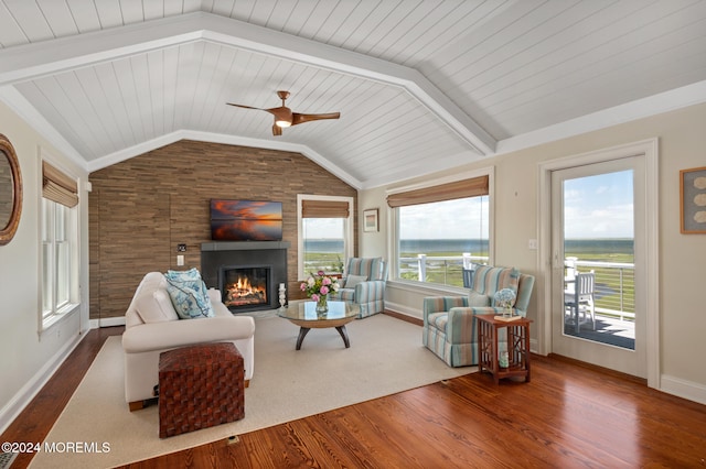 living room featuring vaulted ceiling with beams, hardwood / wood-style flooring, ceiling fan, and wooden ceiling