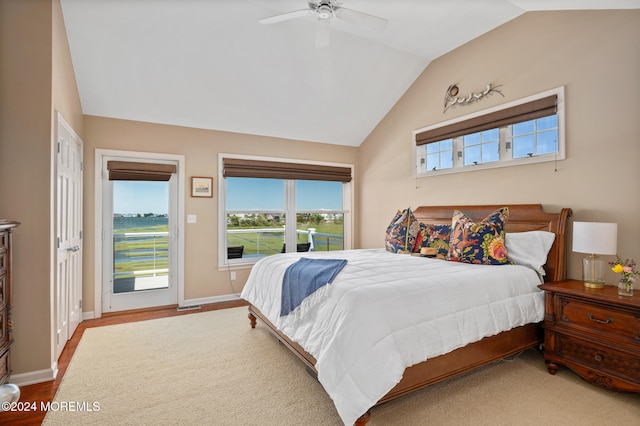 bedroom with hardwood / wood-style floors, ceiling fan, access to outside, and vaulted ceiling