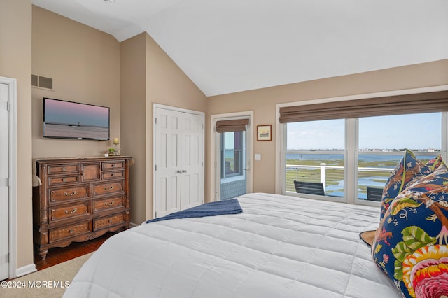 bedroom featuring hardwood / wood-style flooring, vaulted ceiling, and a closet