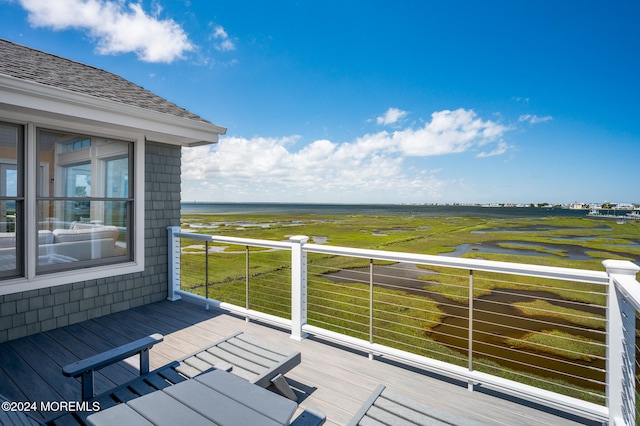 wooden deck featuring a water view