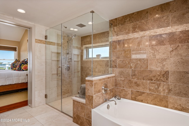 bathroom featuring tile patterned flooring and separate shower and tub