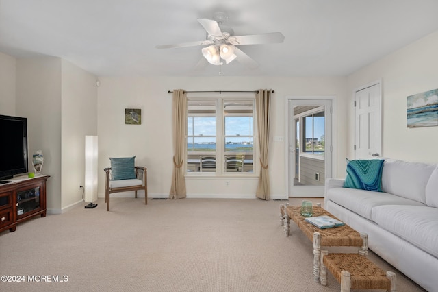 living room with light carpet and ceiling fan