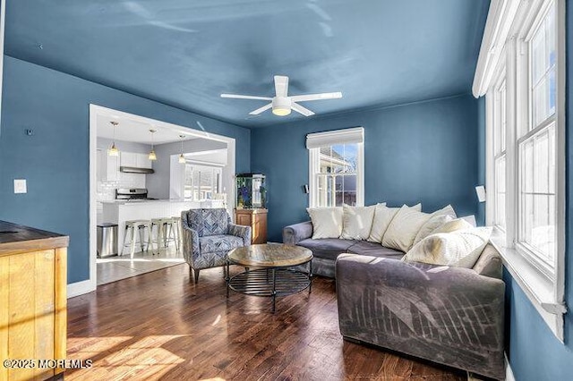 living room with ceiling fan and dark hardwood / wood-style flooring