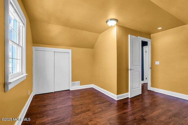 bonus room with dark hardwood / wood-style floors and lofted ceiling