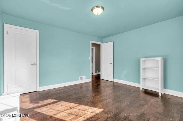 spare room featuring dark hardwood / wood-style floors