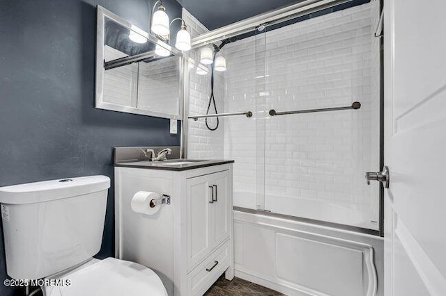 full bathroom featuring toilet, vanity, and shower / bath combination with glass door