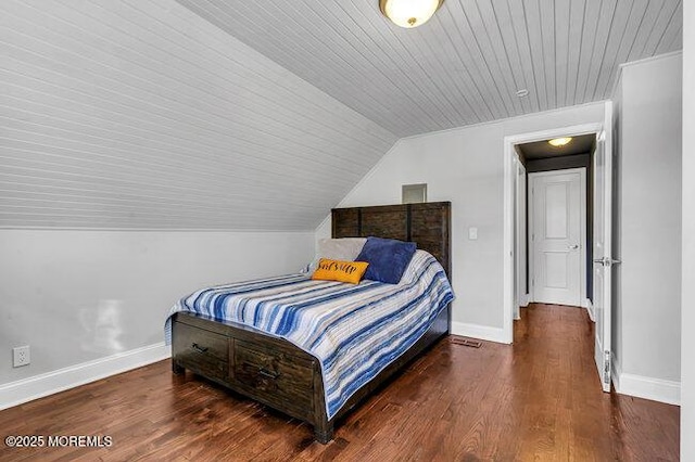 bedroom with dark hardwood / wood-style flooring, lofted ceiling, and wood ceiling