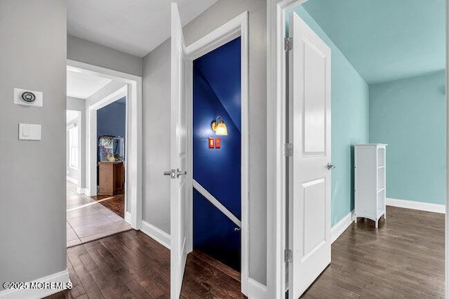 corridor with dark hardwood / wood-style flooring