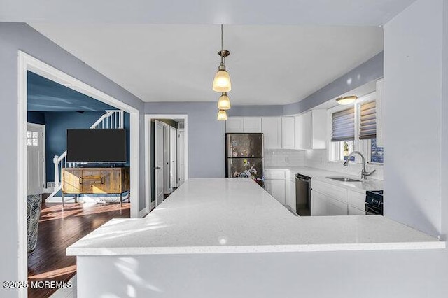 kitchen featuring dishwasher, pendant lighting, decorative backsplash, sink, and white cabinets