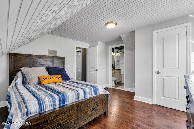 bedroom with dark wood-type flooring, wood ceiling, connected bathroom, and lofted ceiling