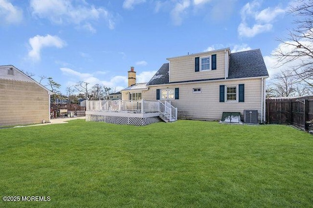 rear view of property with a deck, a lawn, and central air condition unit