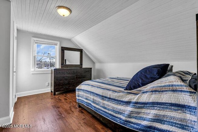 bedroom featuring vaulted ceiling and dark hardwood / wood-style floors