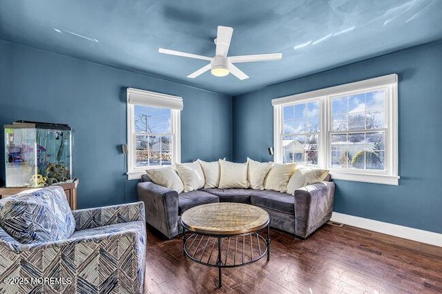 living room featuring ceiling fan and dark hardwood / wood-style floors