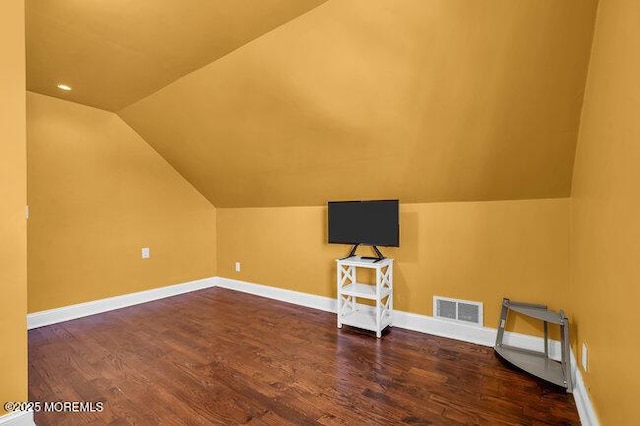 additional living space with dark hardwood / wood-style floors and lofted ceiling