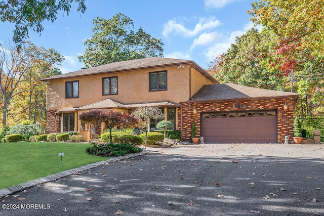 front of property featuring a garage and a front yard