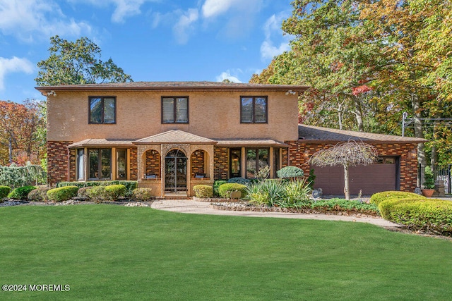 view of front of house with a porch, a garage, and a front yard