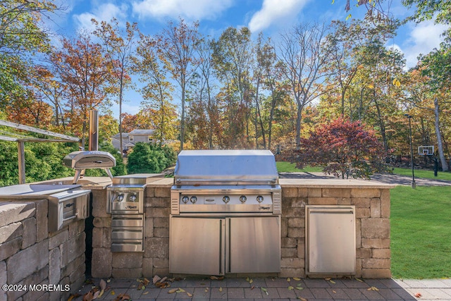 view of patio with area for grilling and a grill