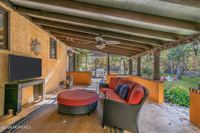 view of patio / terrace with ceiling fan, an outdoor living space, and exterior kitchen