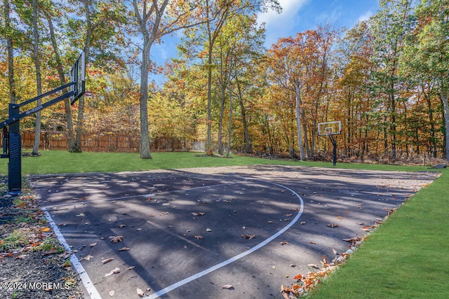 view of basketball court featuring a lawn