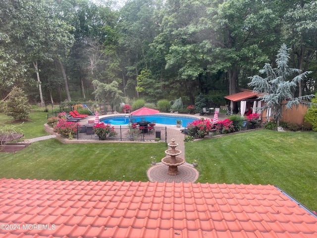 view of pool with a patio area and a yard