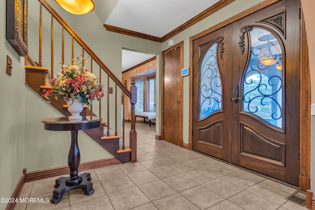 tiled foyer with ornamental molding