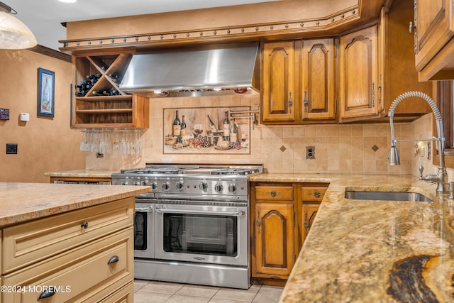 kitchen featuring light stone countertops, sink, exhaust hood, light tile patterned floors, and double oven range