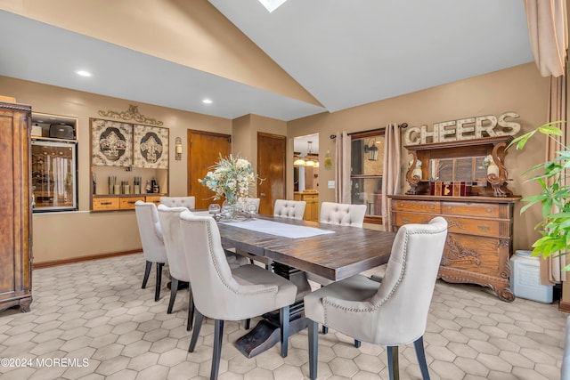 dining space featuring ceiling fan and vaulted ceiling