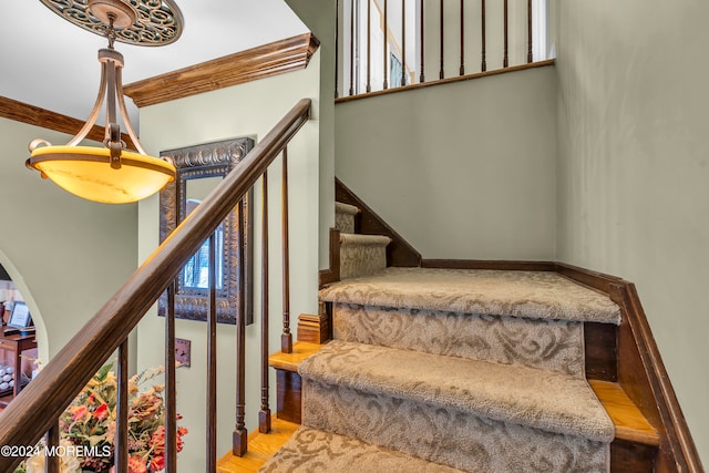 stairway featuring hardwood / wood-style flooring and crown molding