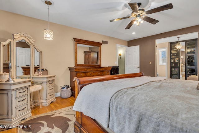 bedroom with ceiling fan and light wood-type flooring