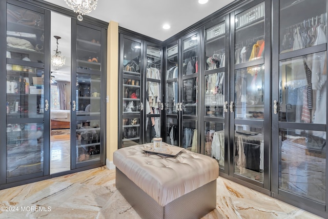 spacious closet featuring an inviting chandelier