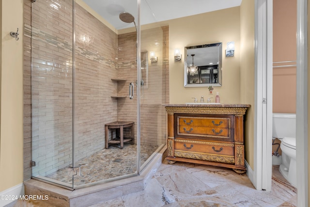 bathroom featuring an enclosed shower, vanity, and toilet