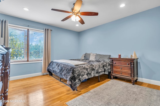 bedroom featuring ceiling fan and light hardwood / wood-style flooring