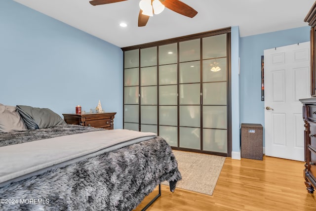 bedroom featuring light wood-type flooring and ceiling fan