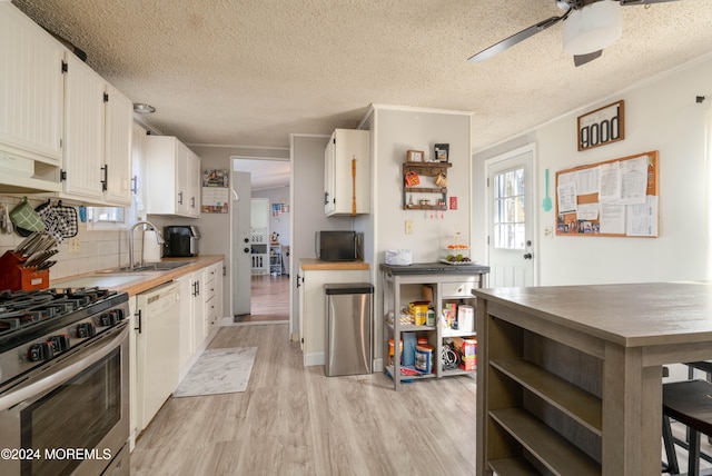 kitchen with dishwasher, white cabinets, ventilation hood, light hardwood / wood-style floors, and stainless steel range with gas stovetop