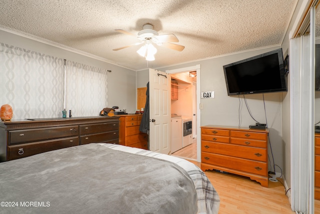 bedroom with ceiling fan, ornamental molding, a textured ceiling, independent washer and dryer, and light hardwood / wood-style floors