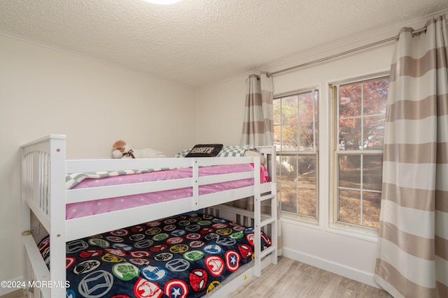 bedroom featuring hardwood / wood-style floors and a textured ceiling