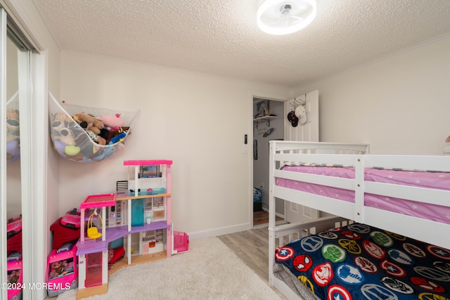 bedroom with a textured ceiling and light carpet