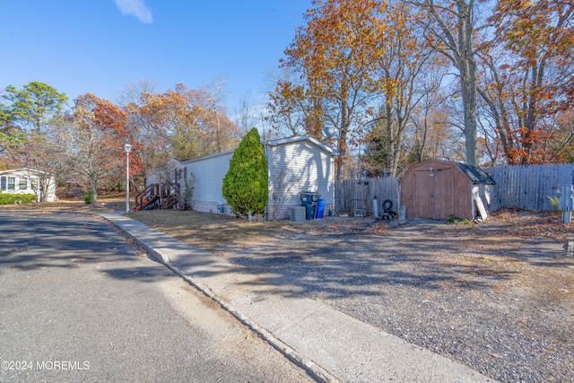 view of side of property with a storage unit