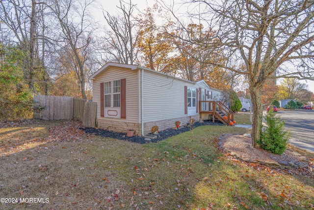 view of side of home with a lawn