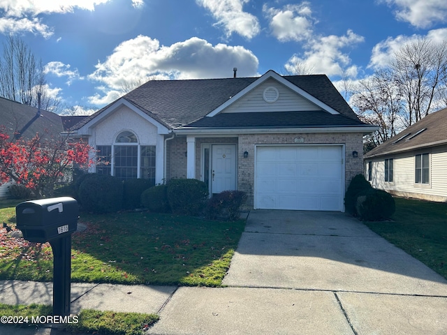 view of front of property featuring a garage and a front lawn