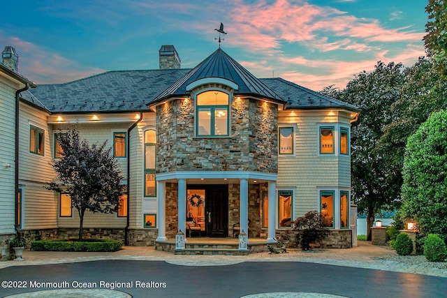 view of back house at dusk