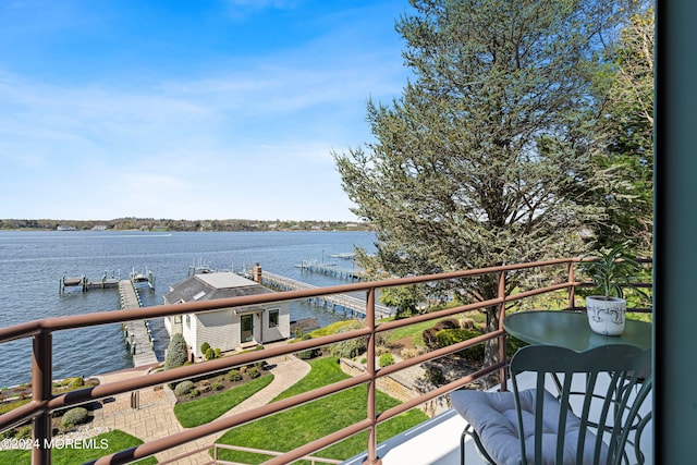 balcony featuring a boat dock and a water view