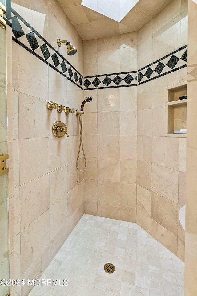 bathroom with a tile shower