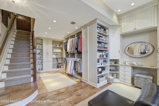 spacious closet with light hardwood / wood-style flooring