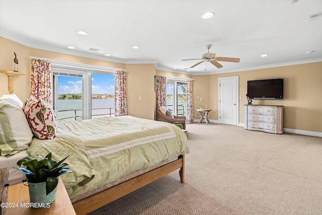 bedroom featuring access to exterior, multiple windows, a water view, and ceiling fan