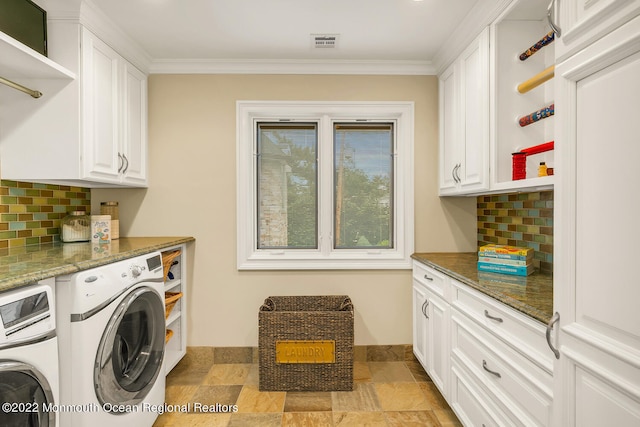 laundry area featuring washer and clothes dryer, cabinets, and crown molding