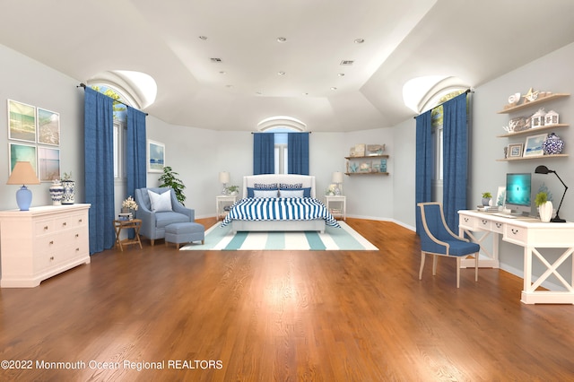 bedroom featuring lofted ceiling and hardwood / wood-style flooring